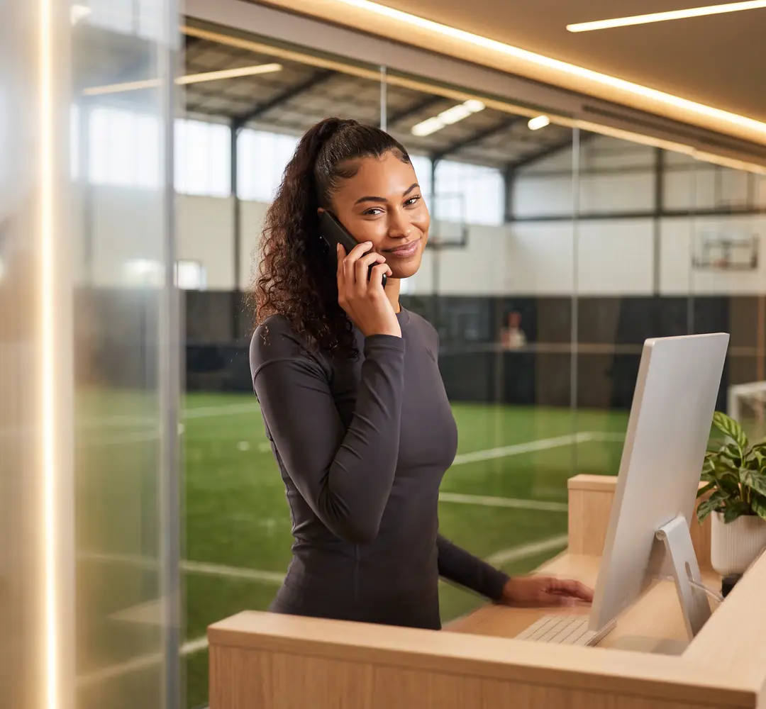 Front-desk staff taking a court booking over the phone
